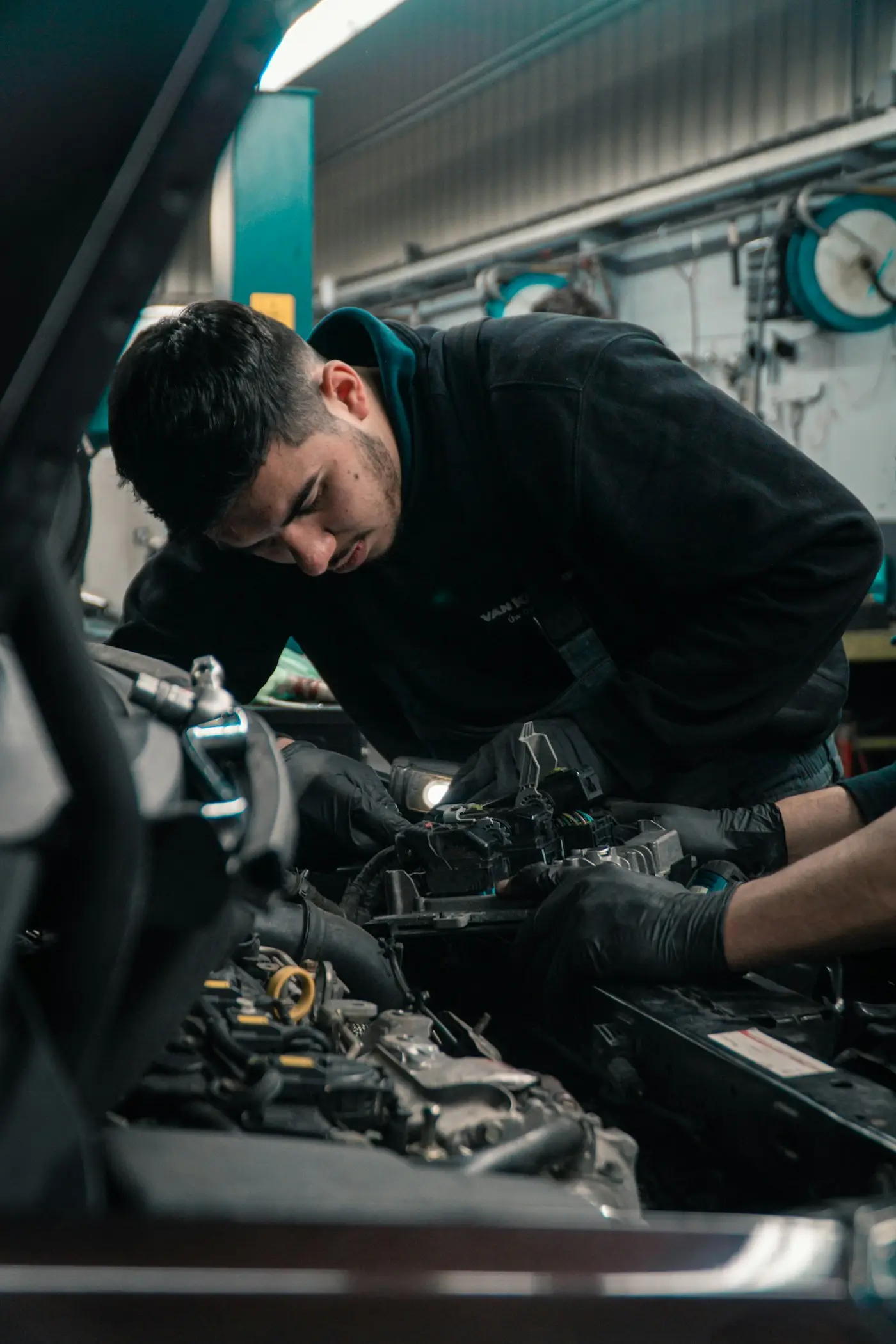 Technician working in an auto repair shop (illustrative stock photo)