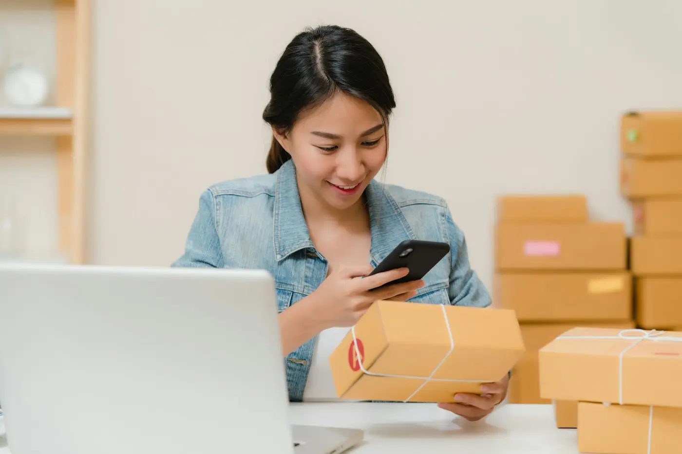 Online seller packing orders for shipment (illustrative stock photo)