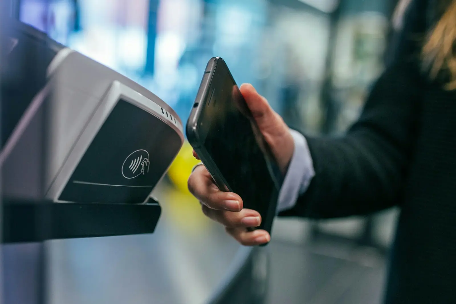 Customer paying with a smartphone (illustrative stock photo)