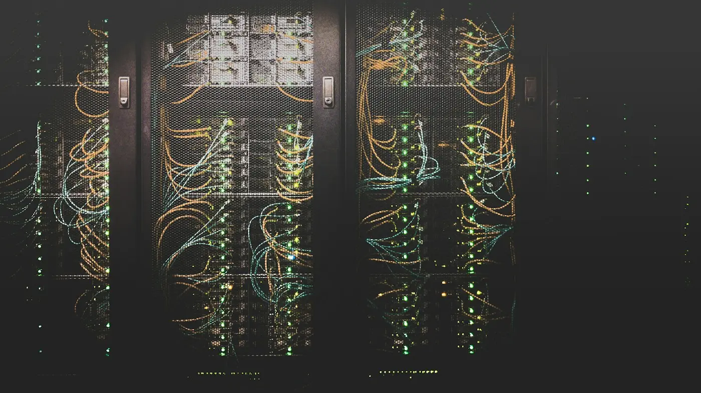 Server racks in a dark data center (illustrative stock photo)